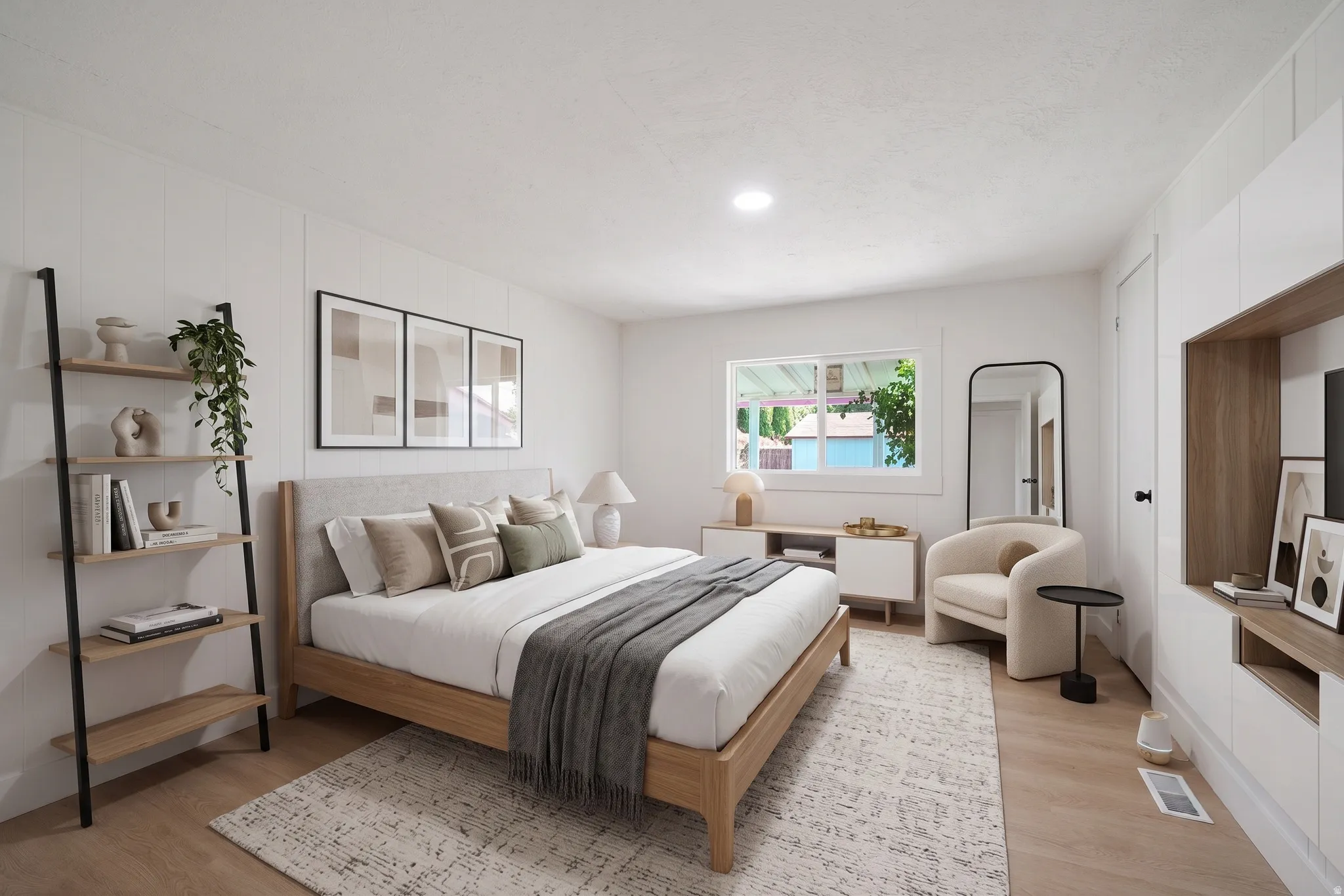 Spacious interior featuring light wood-finish flooring, recessed lighting, and a window with white trim