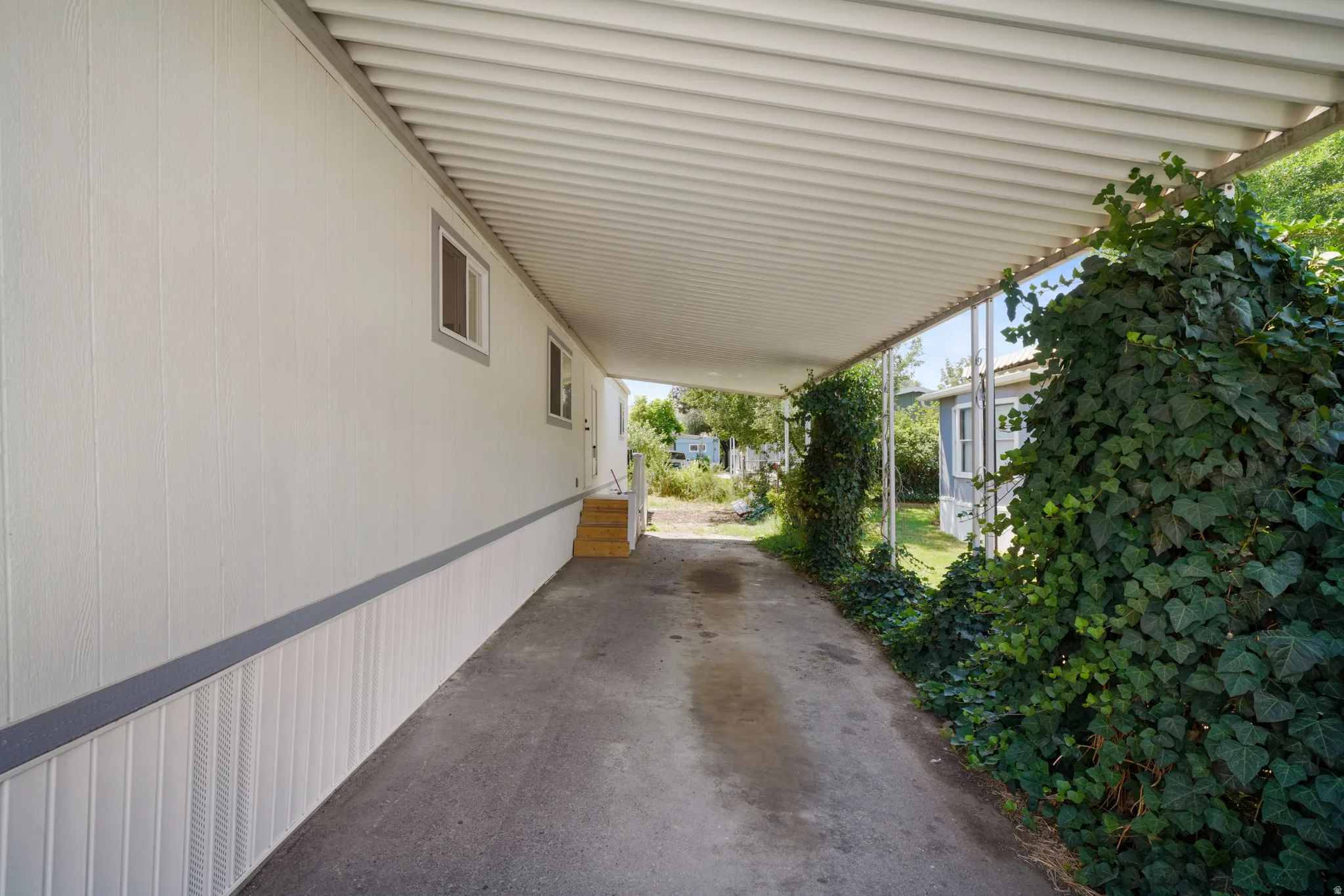 Covered carport with concrete driveway