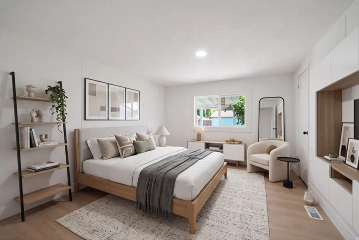 Spacious interior featuring light wood-finish flooring, recessed lighting, and a window with white trim