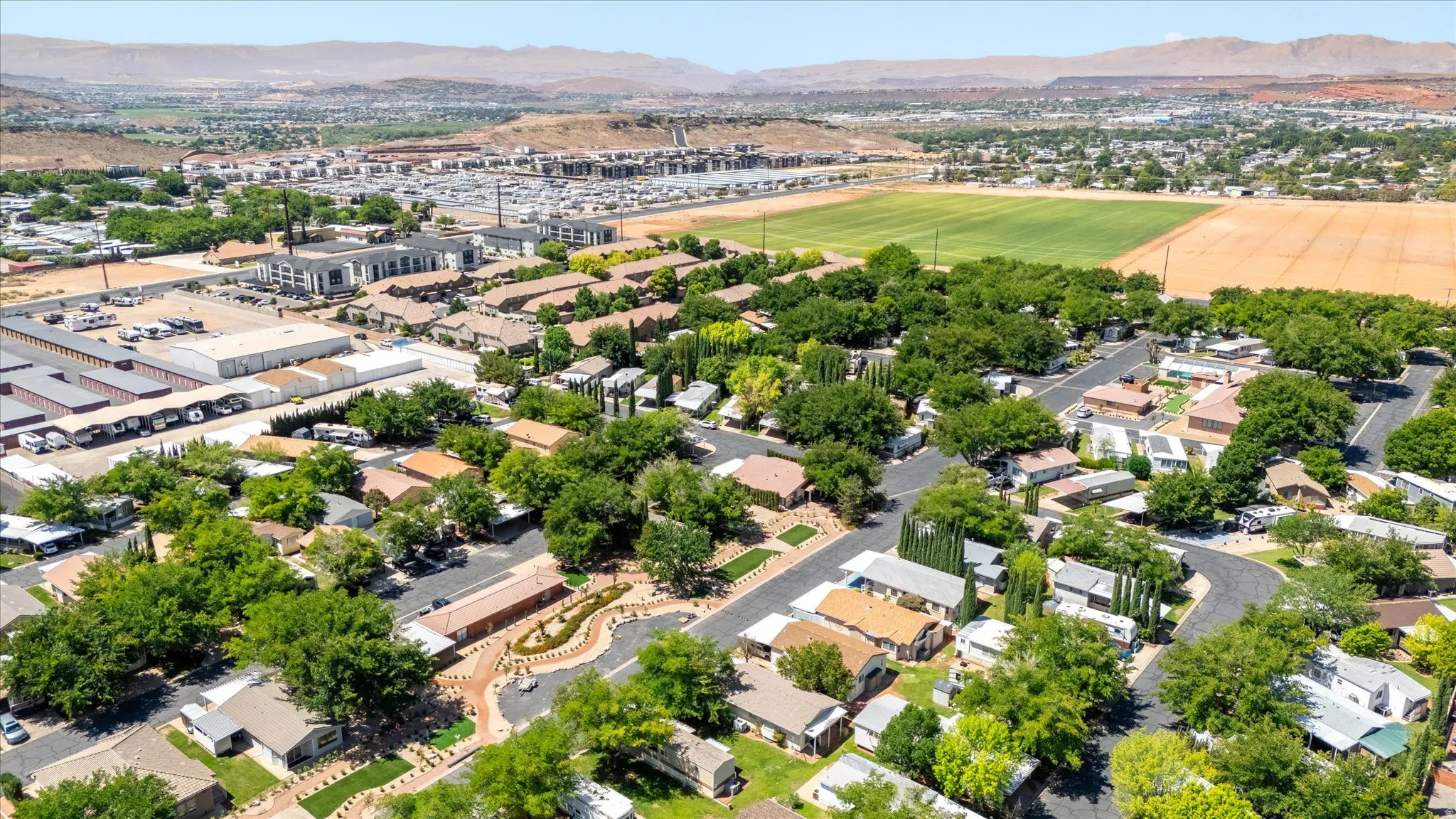 Aerial perspective of a residential neighborhood with mature trees and paved streets