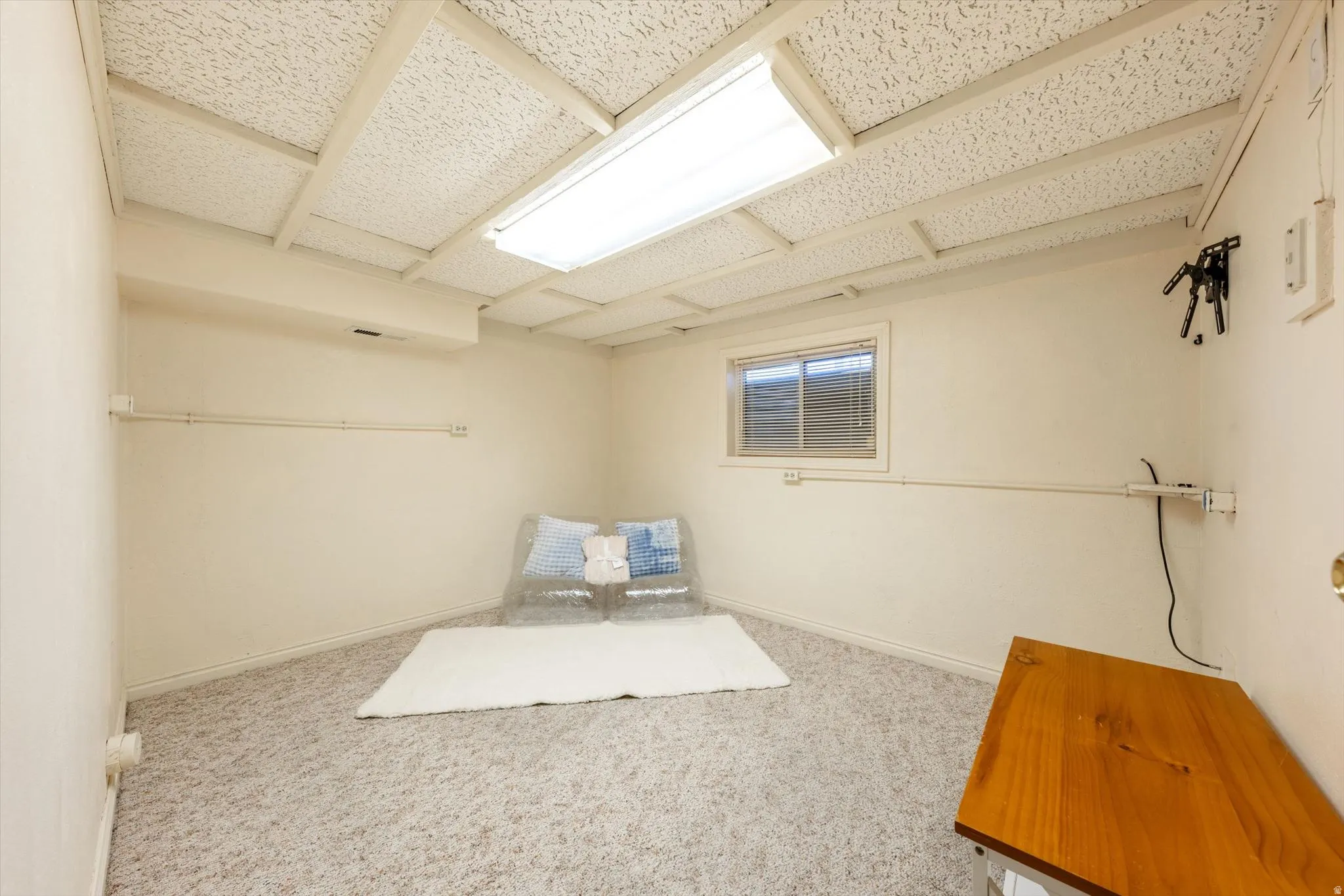 Recessed ceiling with acoustic tiles, fluorescent lighting fixture, and a window with blinds