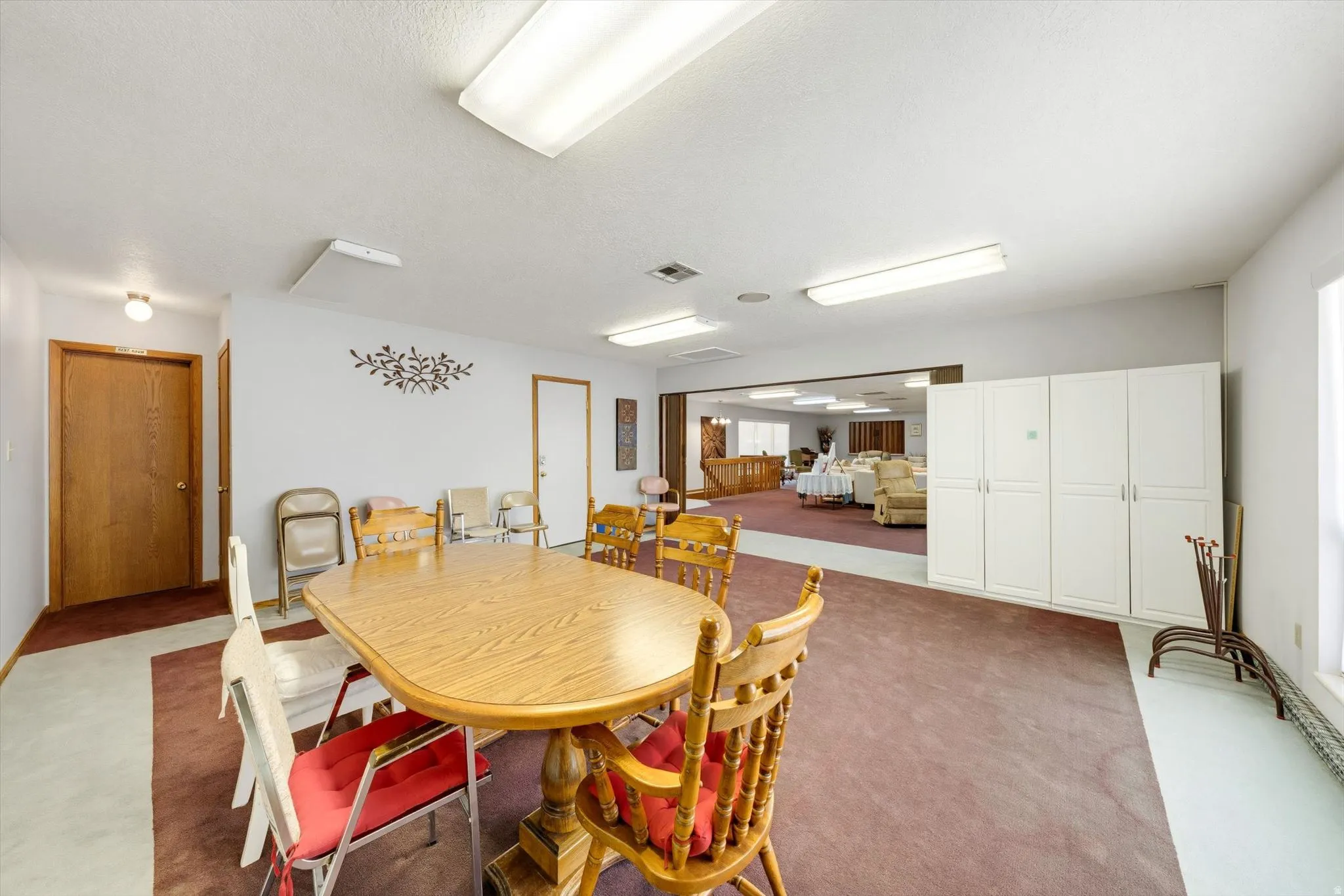 Expansive room featuring recessed lighting, a neutral color palette, and built-in storage cabinetry