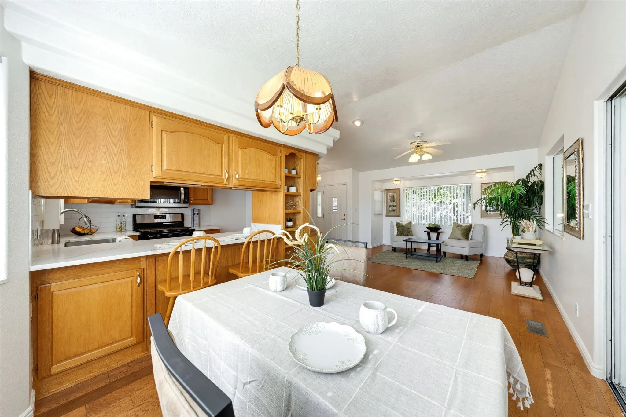 Kitchen featuring wood cabinetry, white countertops, and a white subway tile backsplash