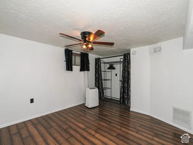 Room featuring wood-finish flooring, a closet and a ceiling floor.