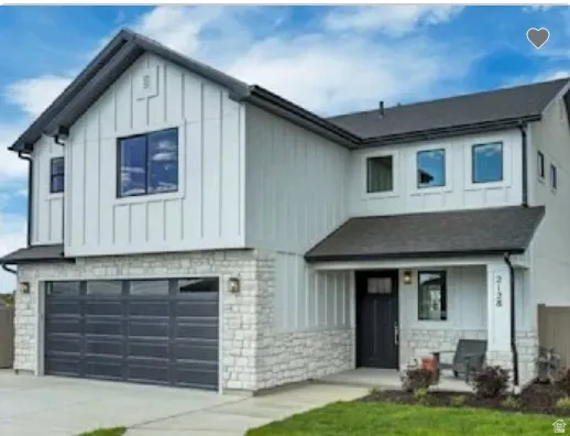 Contemporary two-story residence featuring white board and batten siding with a dark asphalt shingle roof. Home is TO BE BUILT. Pictures are of a similar model.