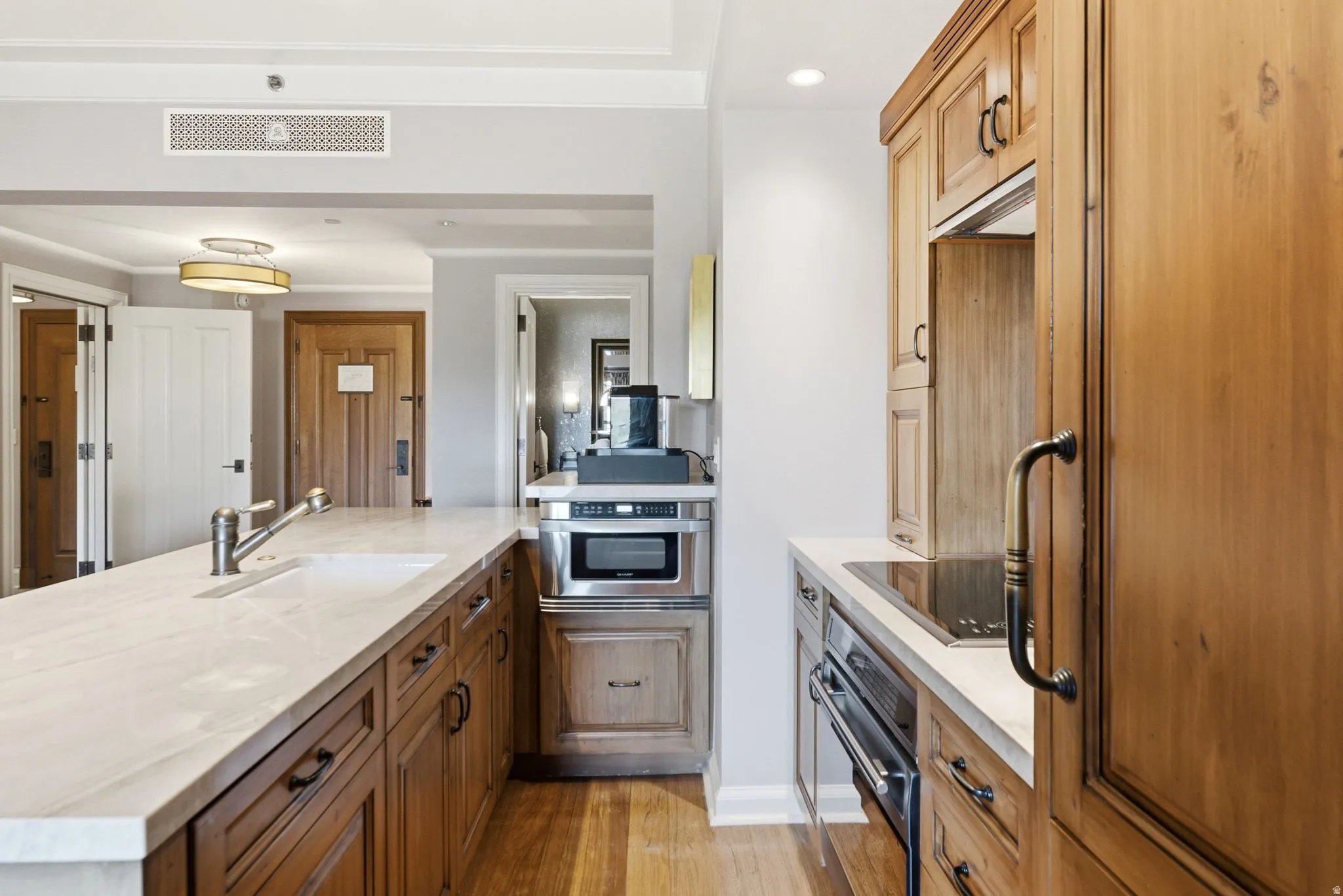 Kitchen featuring wood-finish cabinetry and light-toned countertops