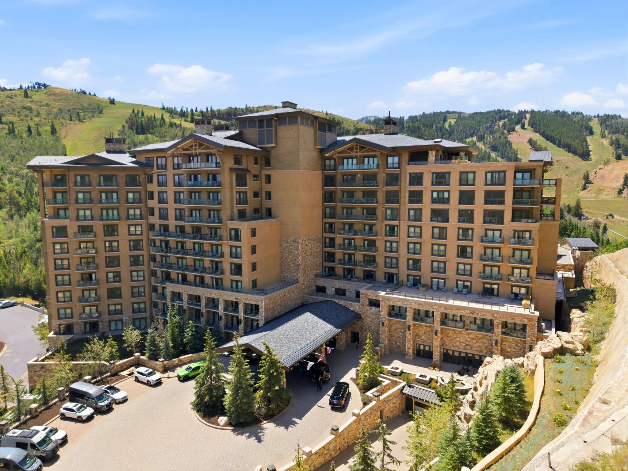 Grand multi-story building featuring extensive stonework and numerous private balconies