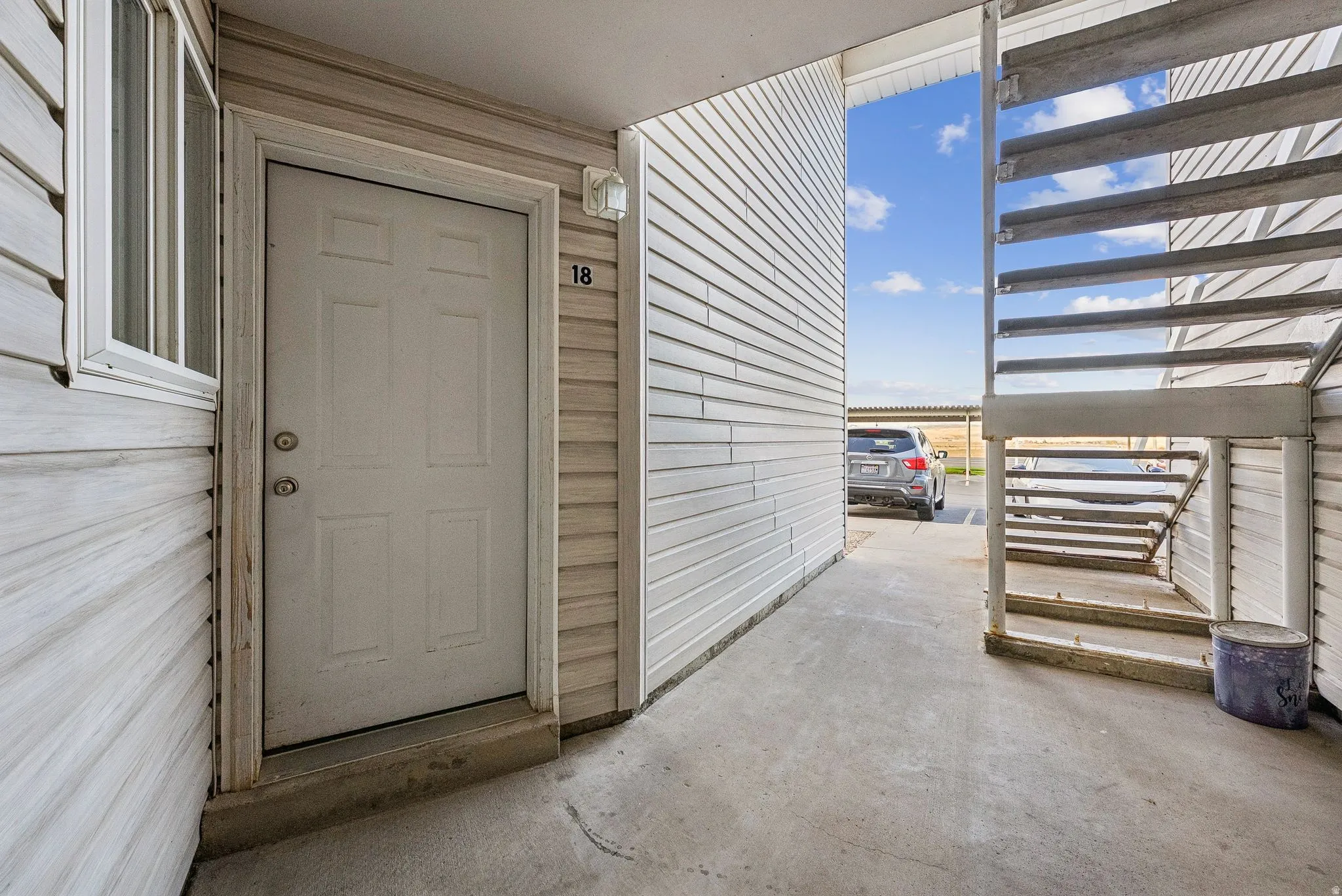 Entryway featuring a panel door, adjacent window, and exterior light fixture