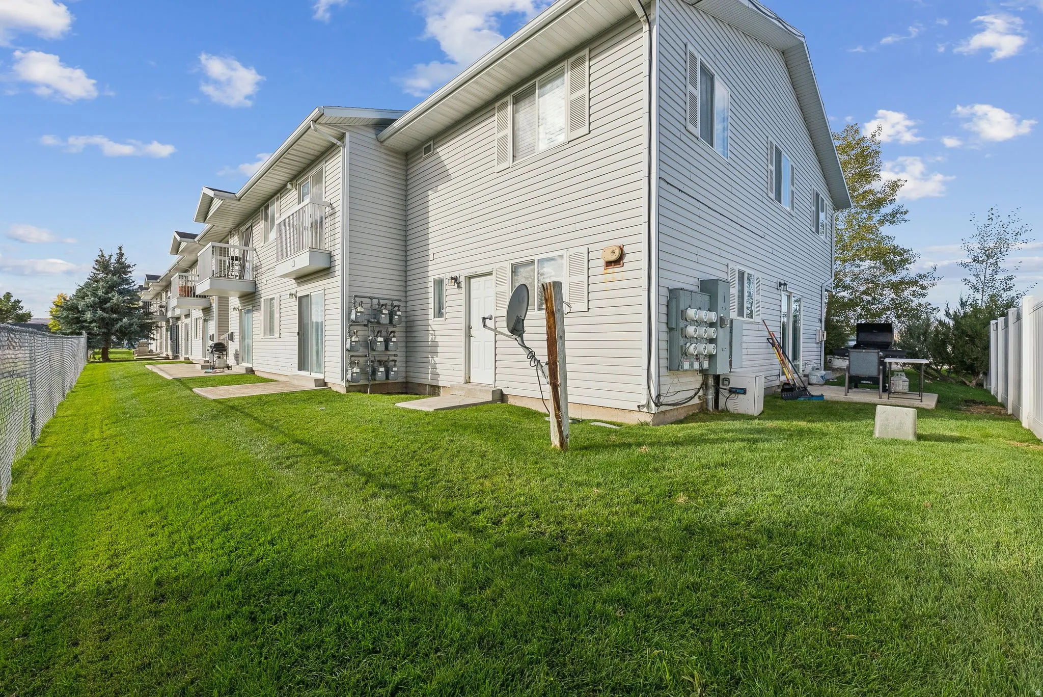 Two-story residential building with light-colored siding