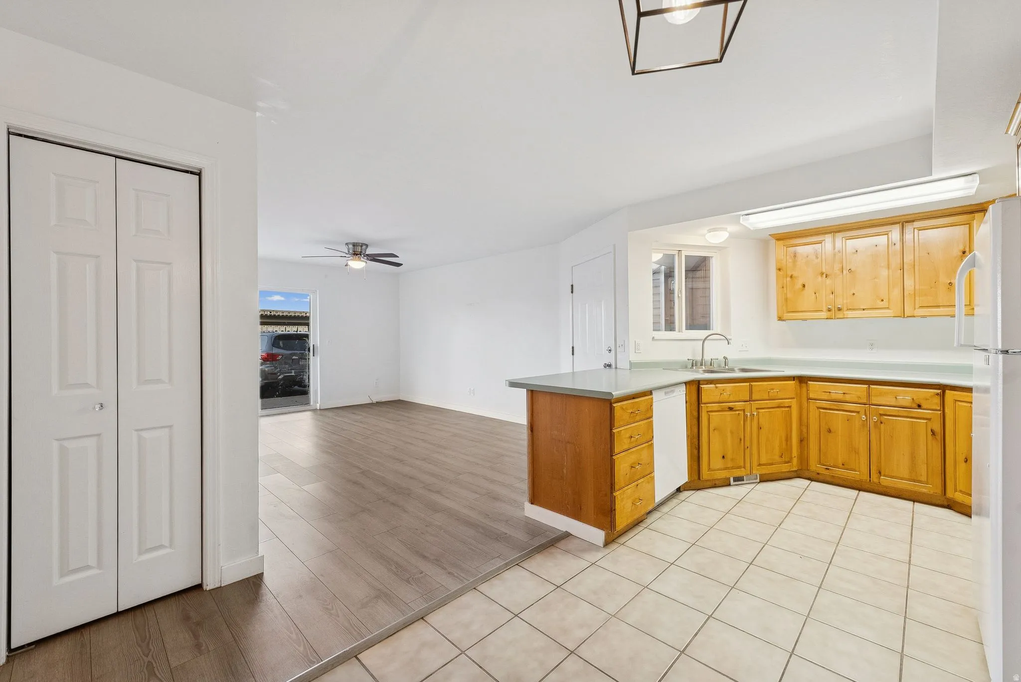 Kitchen featuring wood cabinetry, light countertops, and tile flooring