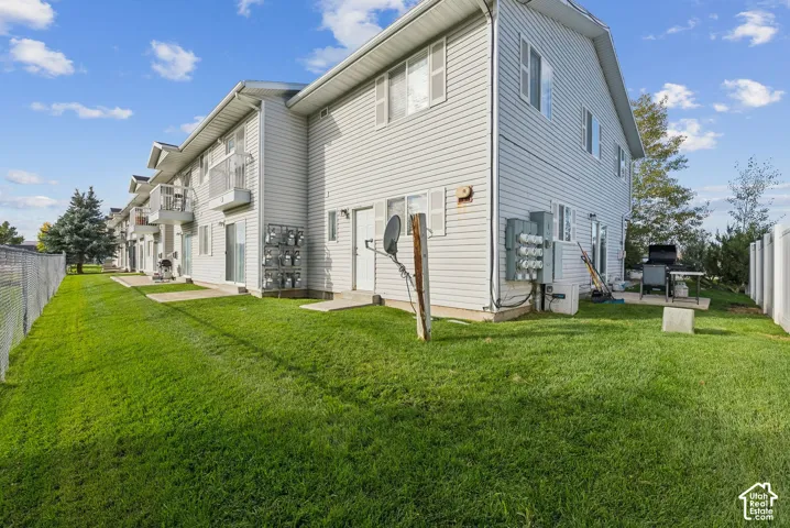 Two-story residential building with light-colored siding