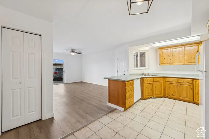 Kitchen featuring wood cabinetry, light countertops, and tile flooring