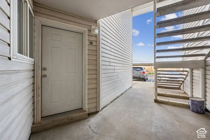 Entryway featuring a panel door, adjacent window, and exterior light fixture