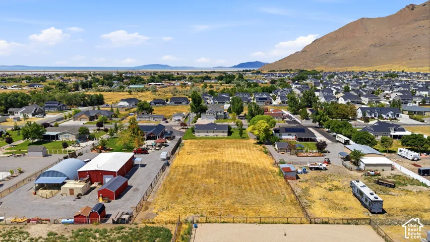 Expansive land parcel featuring open fields and distant mountain scenery