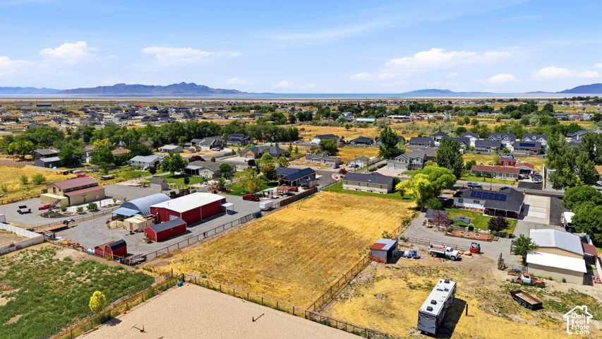 Expansive property featuring multiple outbuildings, including red barns and a large metal-roofed structure