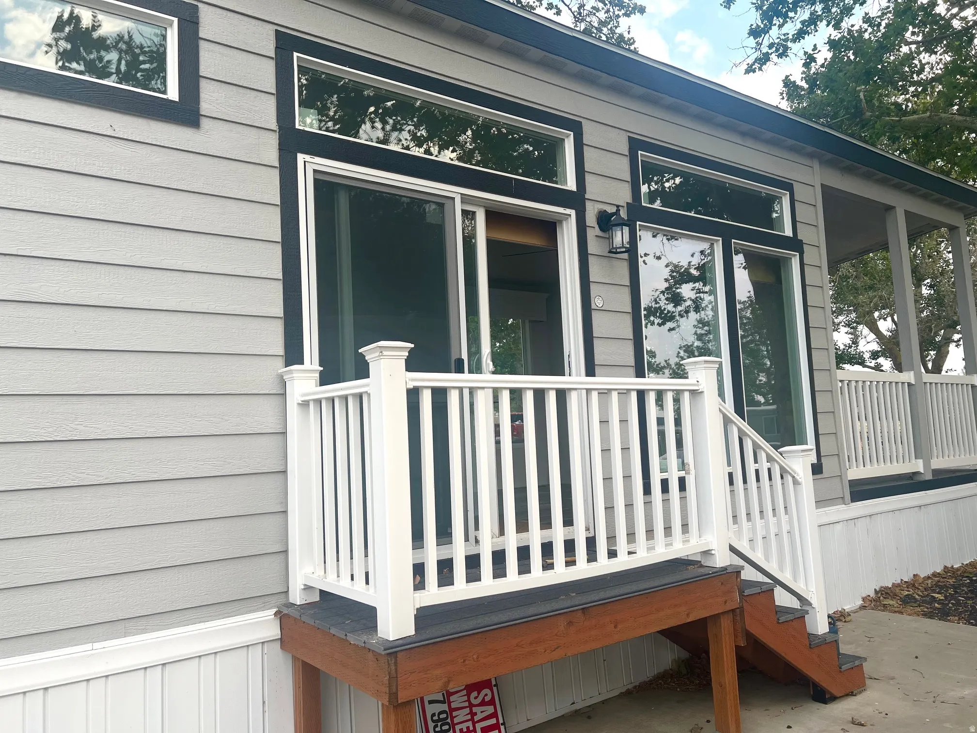 Light gray horizontal siding with black trim details