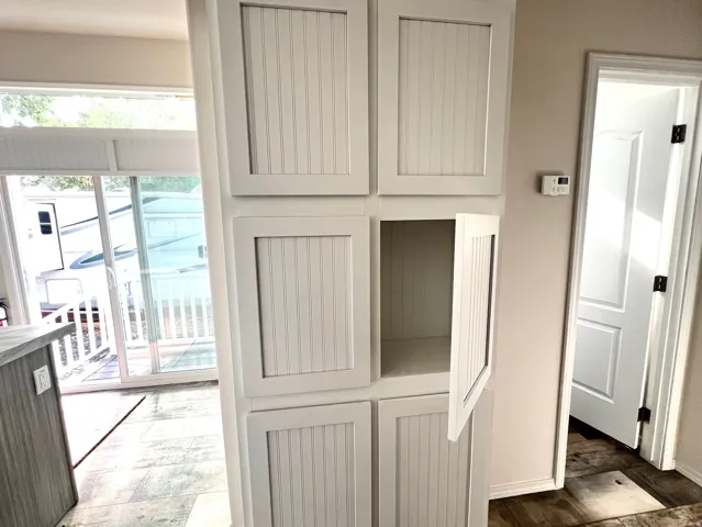 Built-in white beadboard cabinetry offering extensive storage