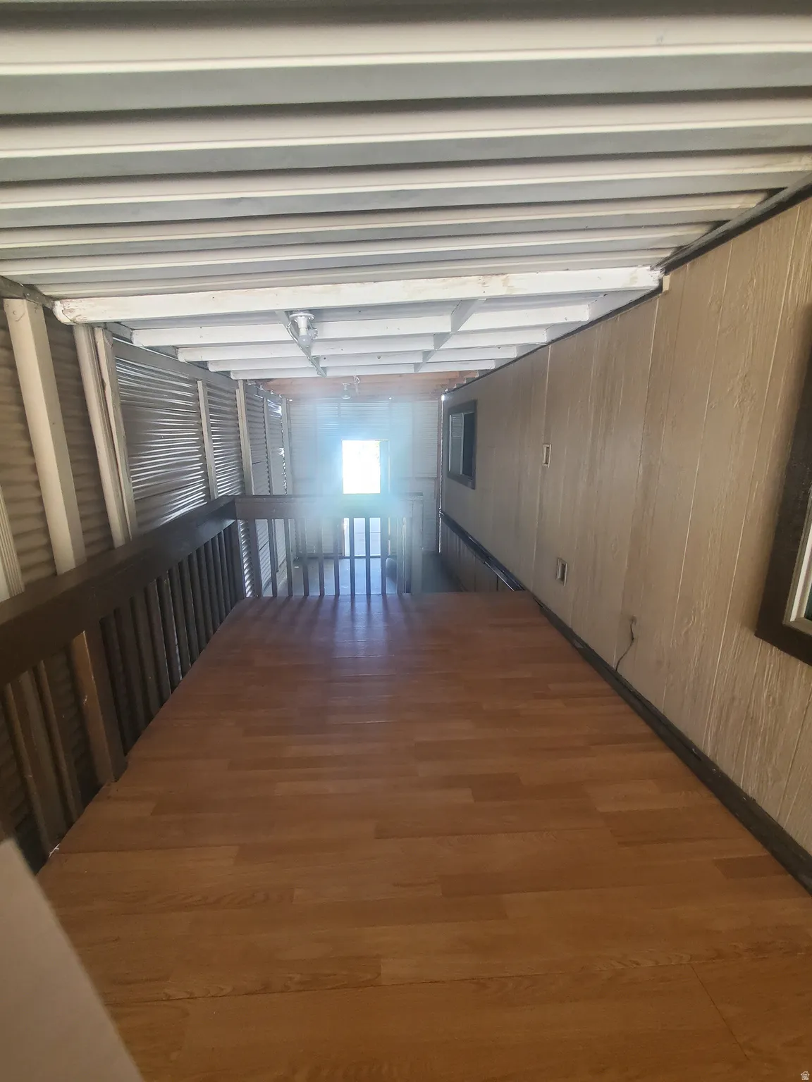 Wood-finish flooring extending through the hallway