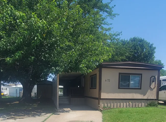Mobile home with light-colored siding and brown trim