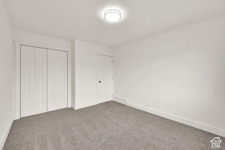 Room featuring light gray carpet, white walls, white trim, and a semi-flush mount ceiling light