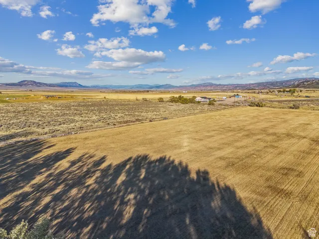 Expansive undeveloped land featuring a combination of cultivated fields and natural vegetation