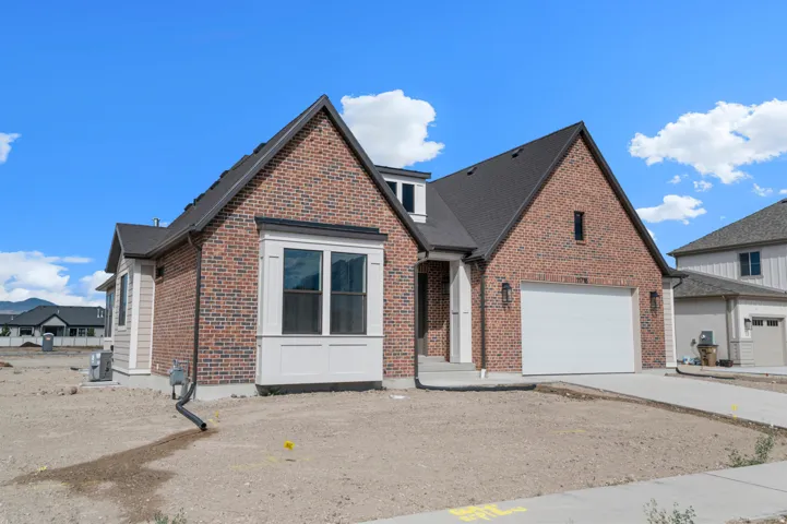 Brick exterior with dark shingle roofing