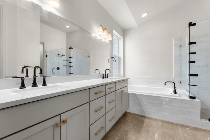 Dual vanity with white countertops and matte black fixtures