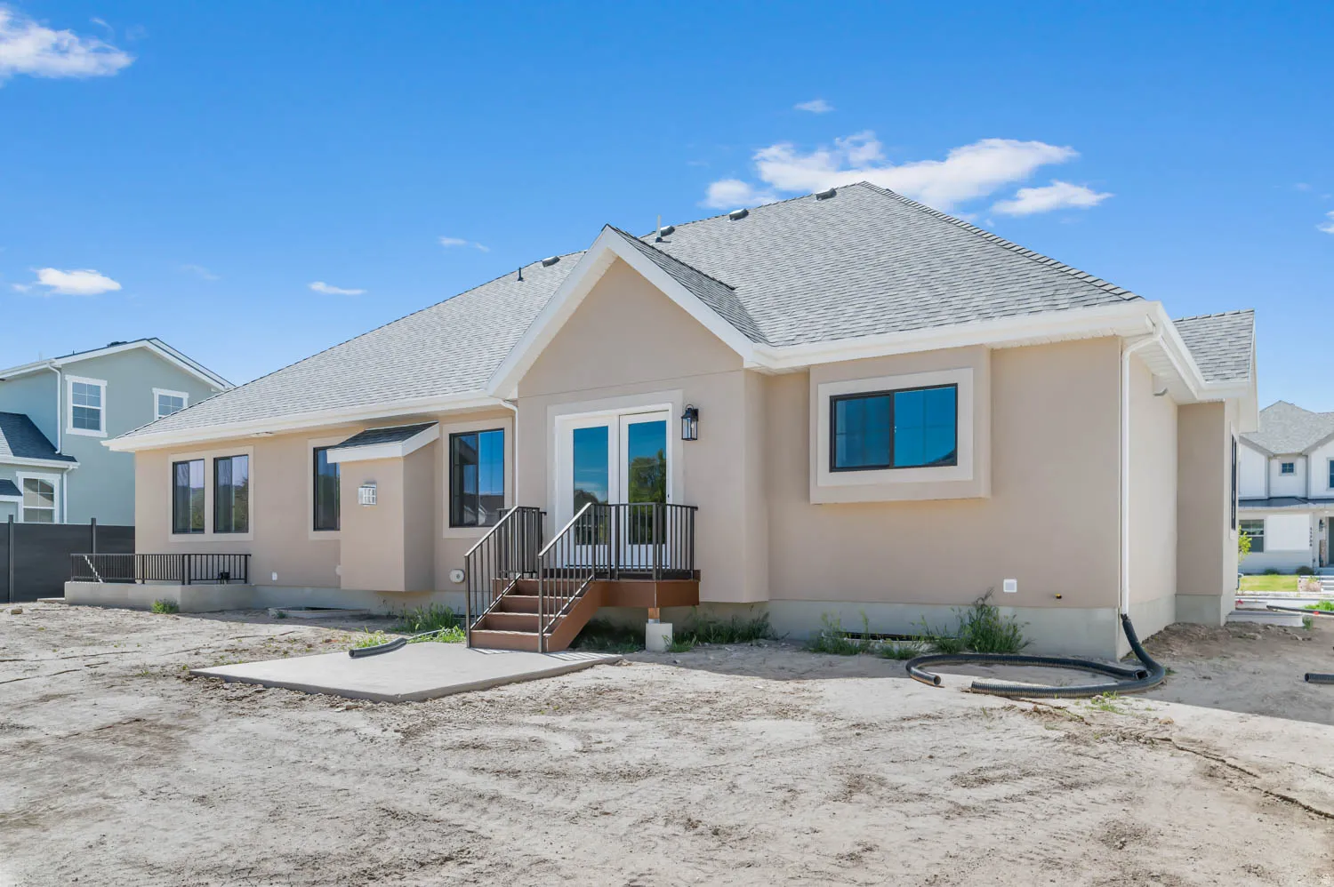 Stucco exterior with a pitched shingle roof