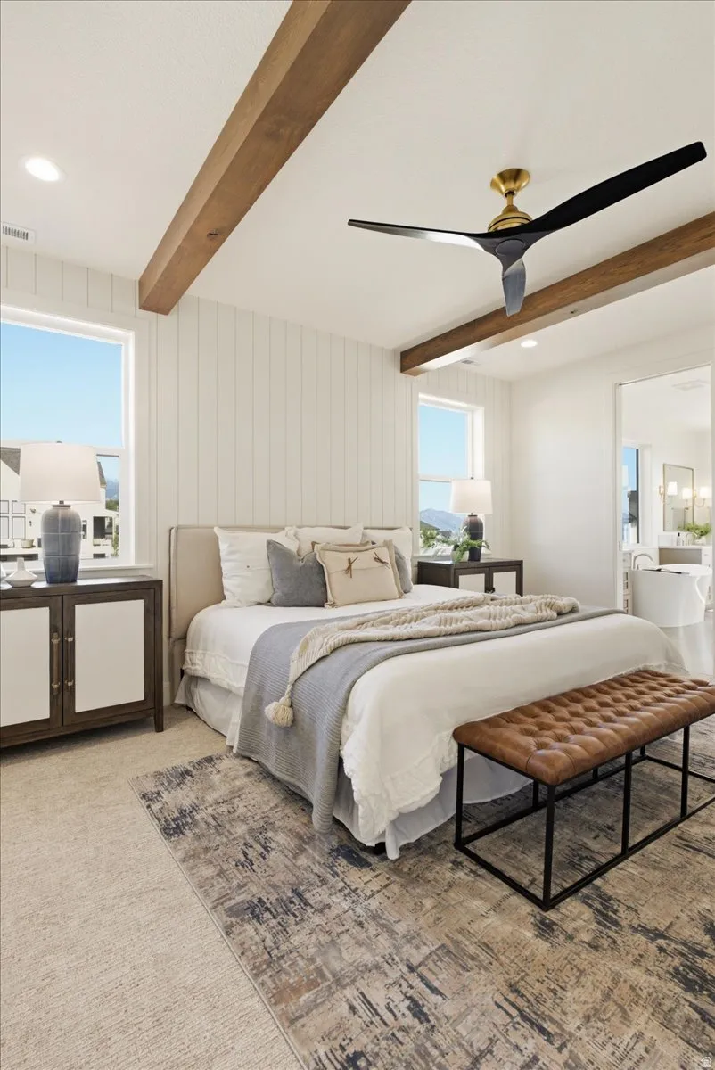 Vaulted ceiling with exposed wood beams and recessed lighting