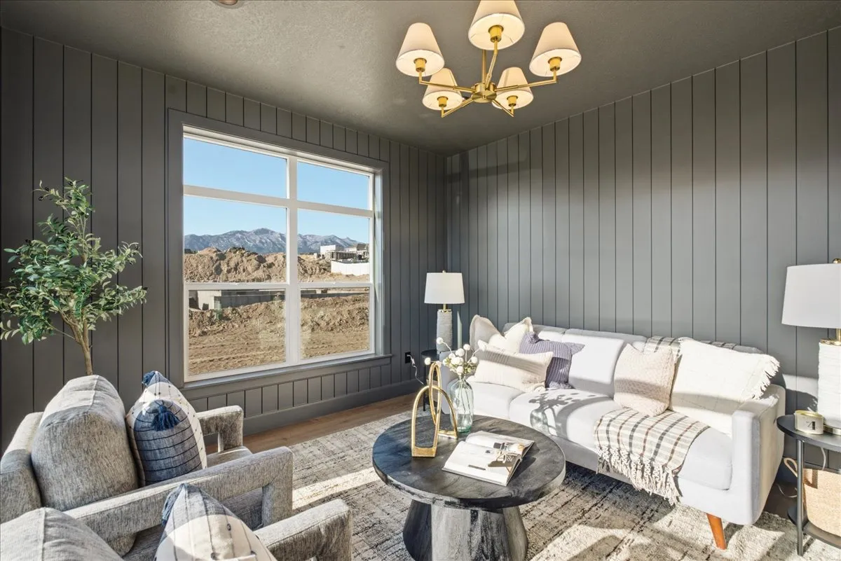 Wall-mounted paneling accents this room with a large picture window
