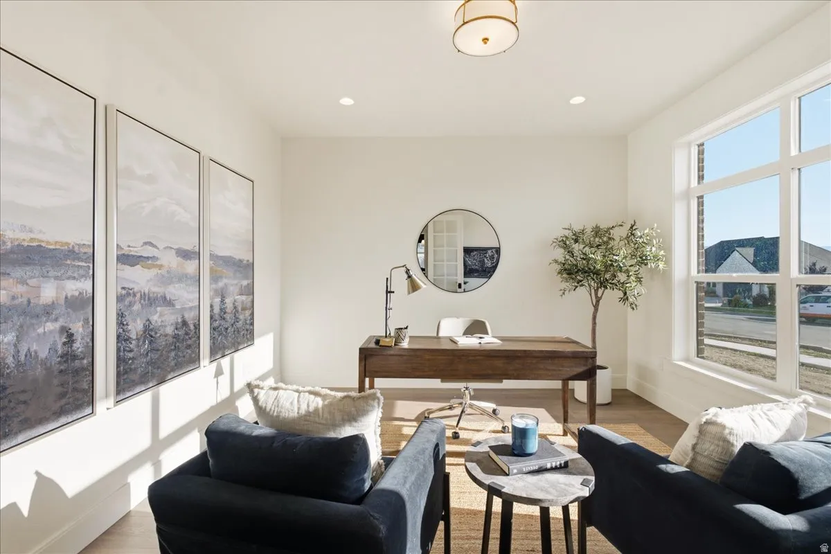 Bright room featuring large window, recessed lighting, and wood-finish flooring
