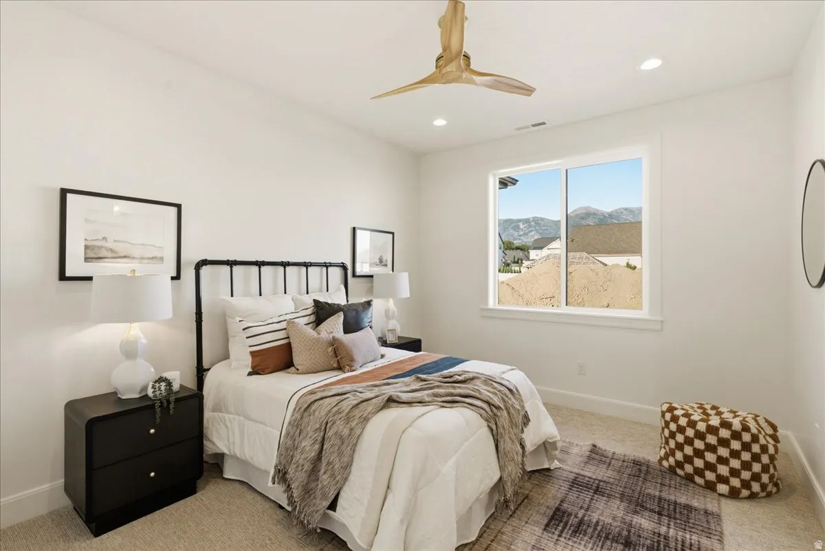 Carpeted room featuring a white window with mountain scenery, recessed lighting, and a wood-finish ceiling fan