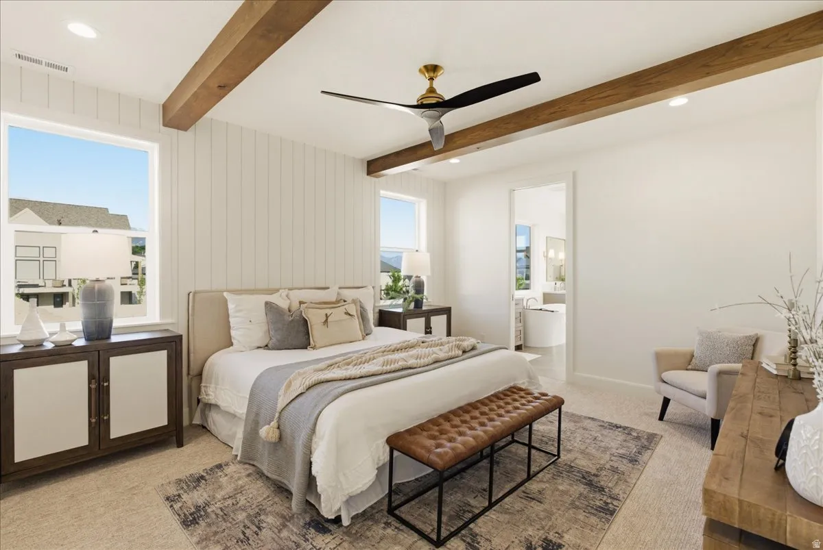 Carpeted sleeping area featuring ceiling-mounted wooden beams and a gold and black ceiling fan