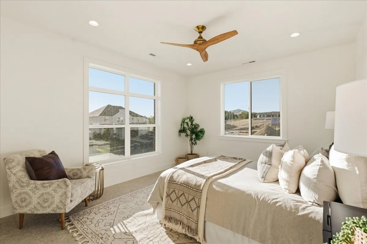 Bright room with large windows, recessed lighting, and a wood-finish ceiling fan