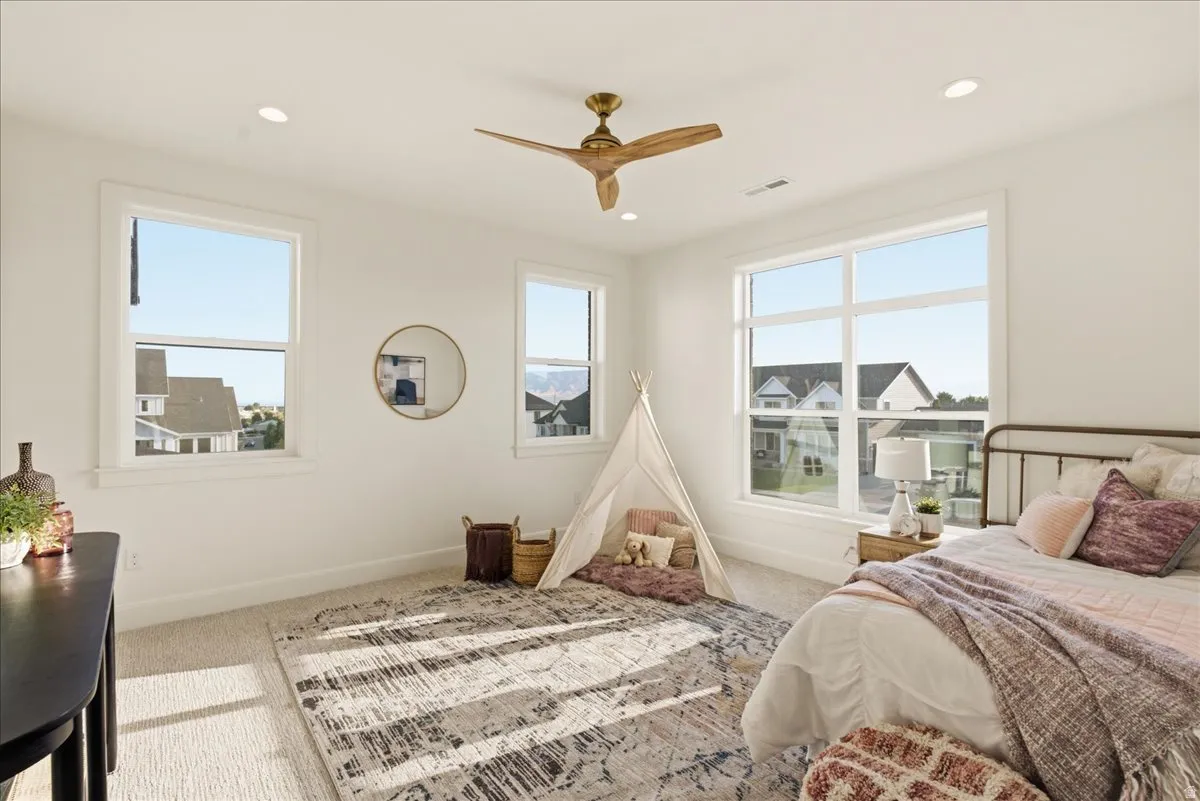 Bright interior space featuring multiple windows, recessed lighting, and a ceiling fan