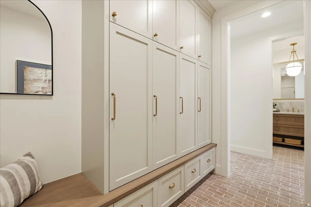 Built-in cabinetry with brass hardware and wood-finish bench seating