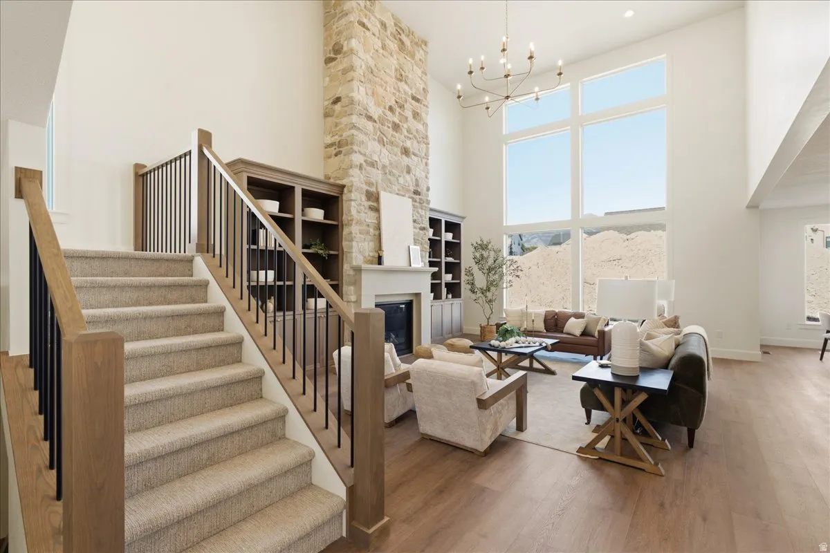 Carpeted staircase with wood-finish handrails and black balusters
