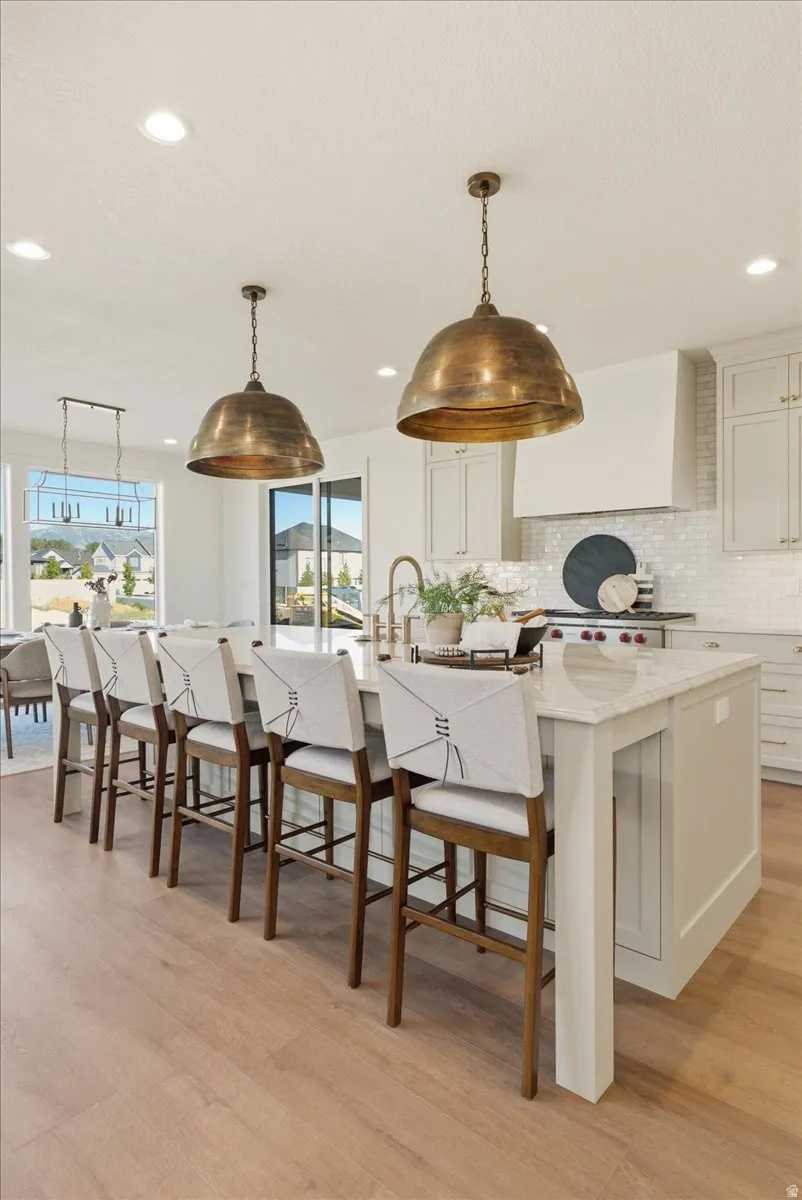 Spacious kitchen island with a light-toned countertop, integrated sink, and seating for five