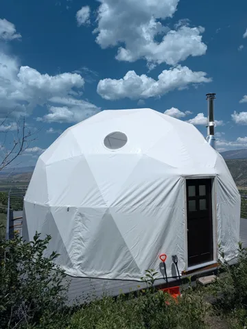 White geodesic dome structure on an elevated deck