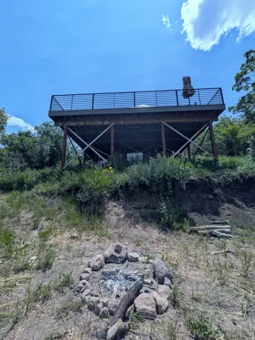 Elevated outdoor deck with horizontal metal railings