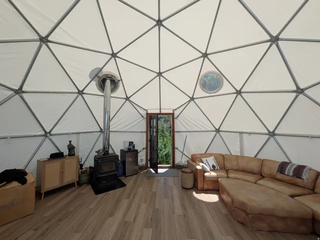 Spacious geodesic dome interior featuring a wood-finish flooring