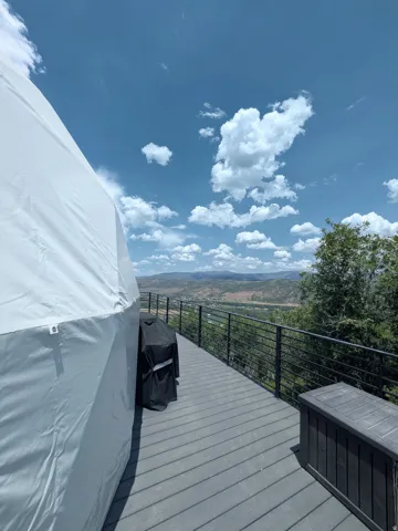 Elevated composite deck with cable railing system and panoramic landscape backdrop