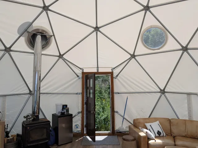 Geodesic dome interior featuring a metal structural frame and white fabric walls