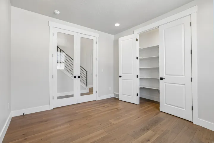 Light wood-finish flooring complements the neutral wall tones
