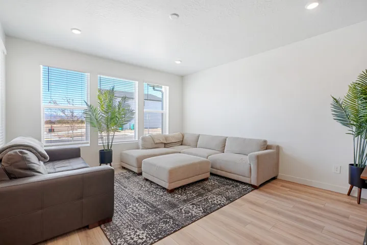 Bright living area featuring wood-finish flooring and recessed ceiling lights