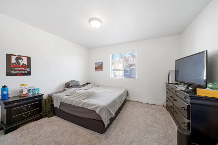 Room featuring neutral carpet flooring, white walls, and a single window with horizontal blinds
