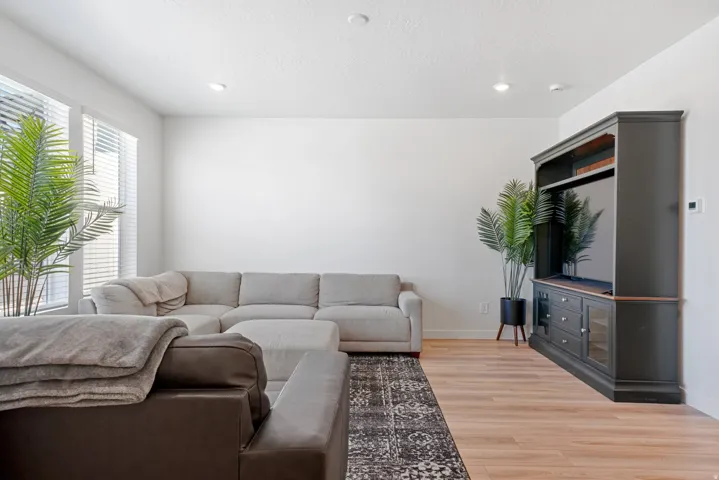 Bright living area featuring wood-finish flooring and recessed lighting