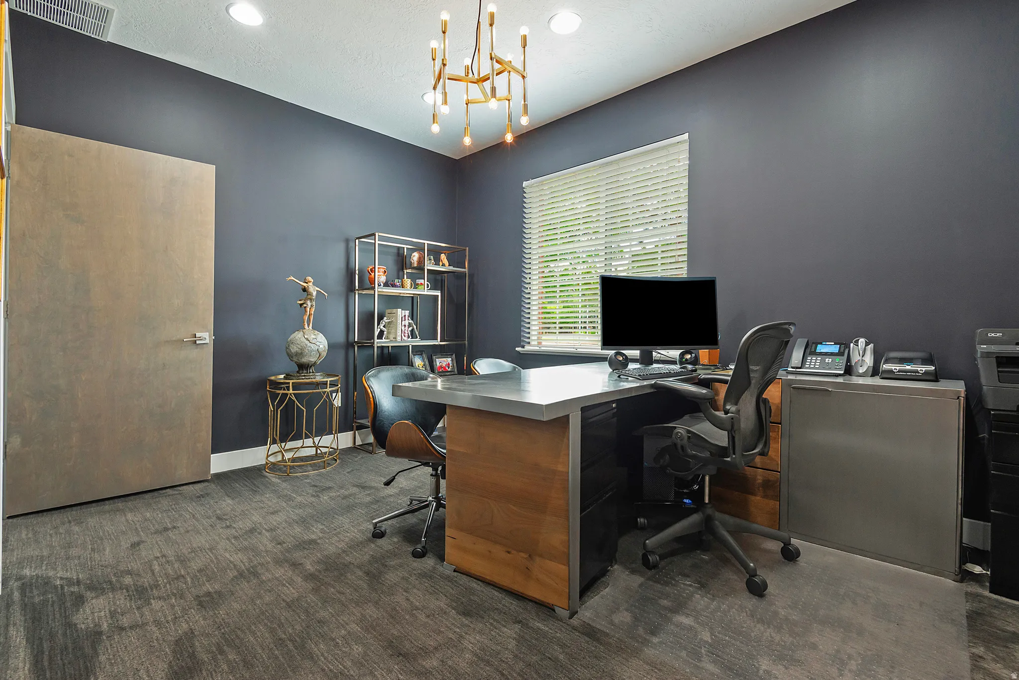 Dedicated office space featuring dark accent walls and patterned carpeting