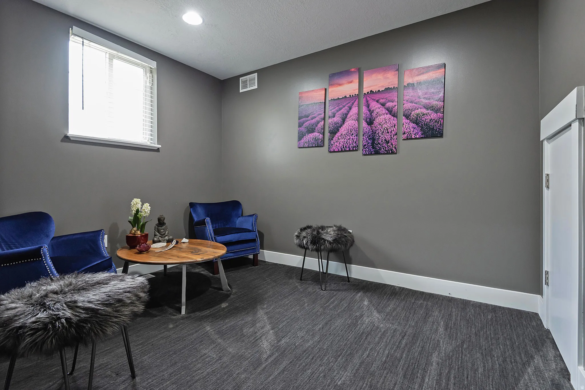Neutral tone wall paint with white baseboards, recessed ceiling lighting, and a window with blinds