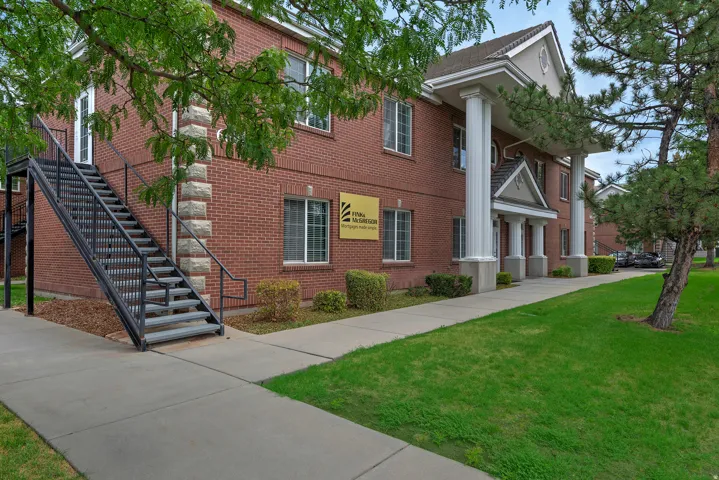 Brick exterior with a prominent portico featuring four large columns